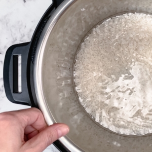 aggitating instant pot liner with jasmine rice inside