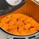 breaded chicken in an air fryer basket