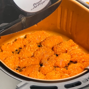 breaded chicken in an air fryer basket