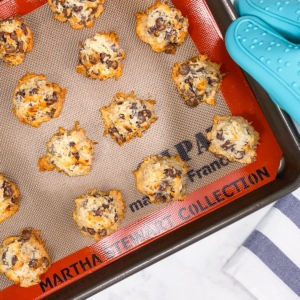 chocolate chip coconut macaroons on a silicone baking sheet after baking