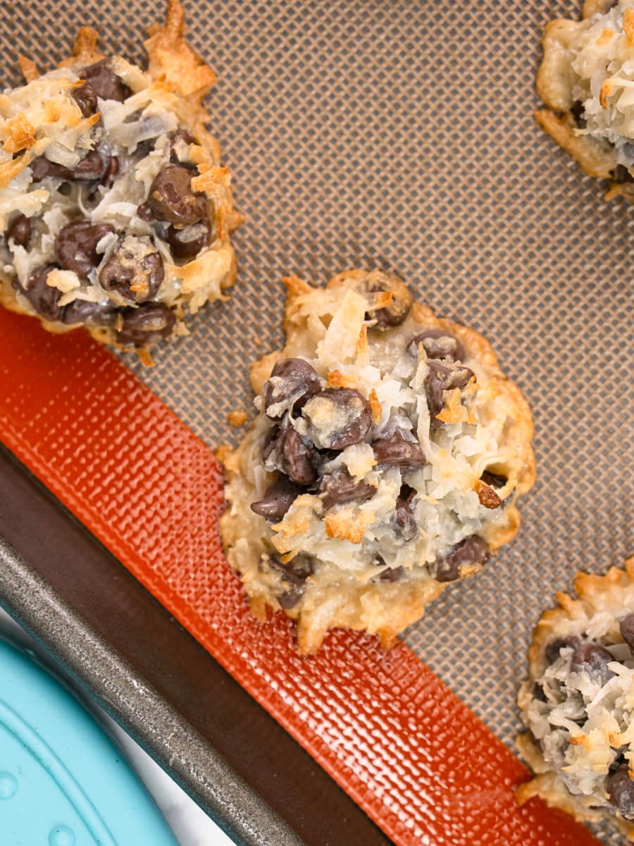 chocolate chip coconut macaroons on a silicone baking sheet after cooking