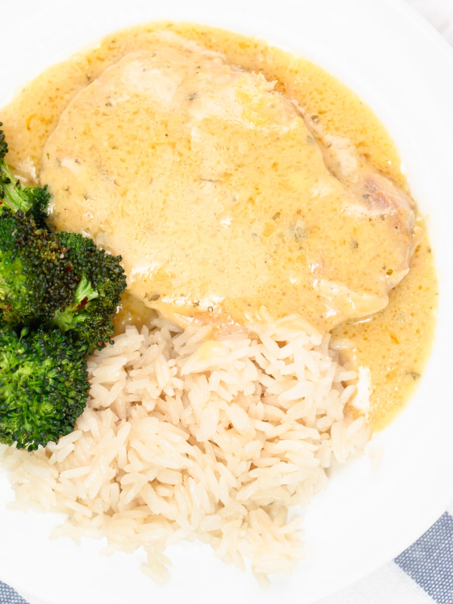 crock pot ranch pork chops on a plate with broccoli and rice