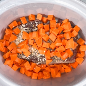 cubed sweet potato over a chuck roast in the slow cooker