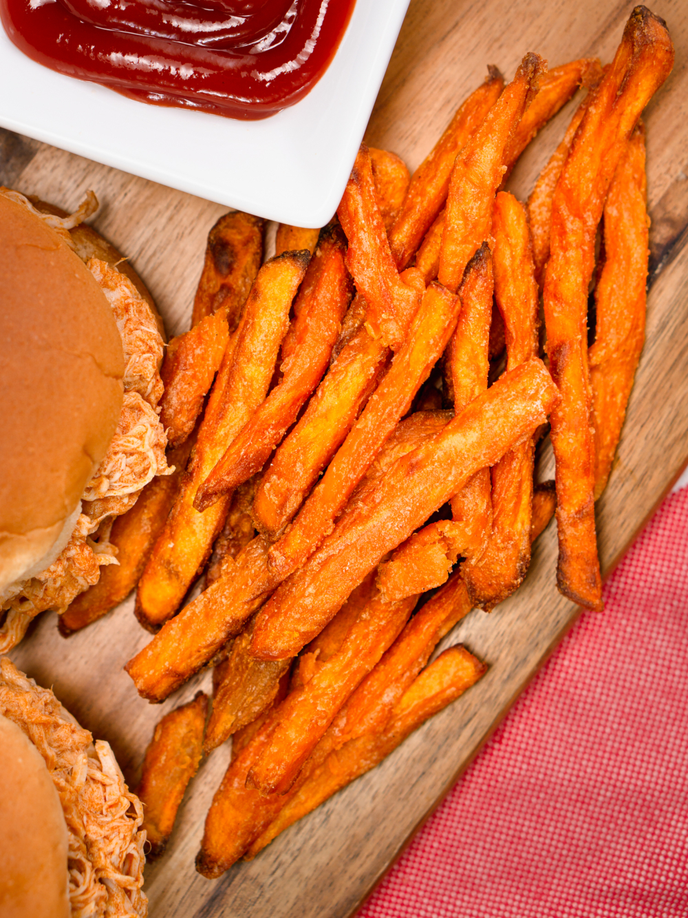 sweet potato fries on a serving board with a small bowl of ketchup