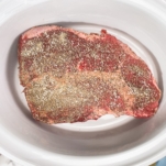 seasoned chuck roast sitting in the slow cooker