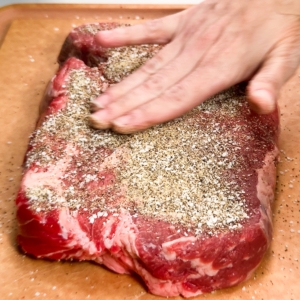 rubbing seasoning into chuck roast