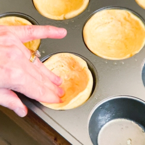 shaping corn bread cups in a cupcake pan