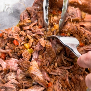 shredding a chuck roast with a fork