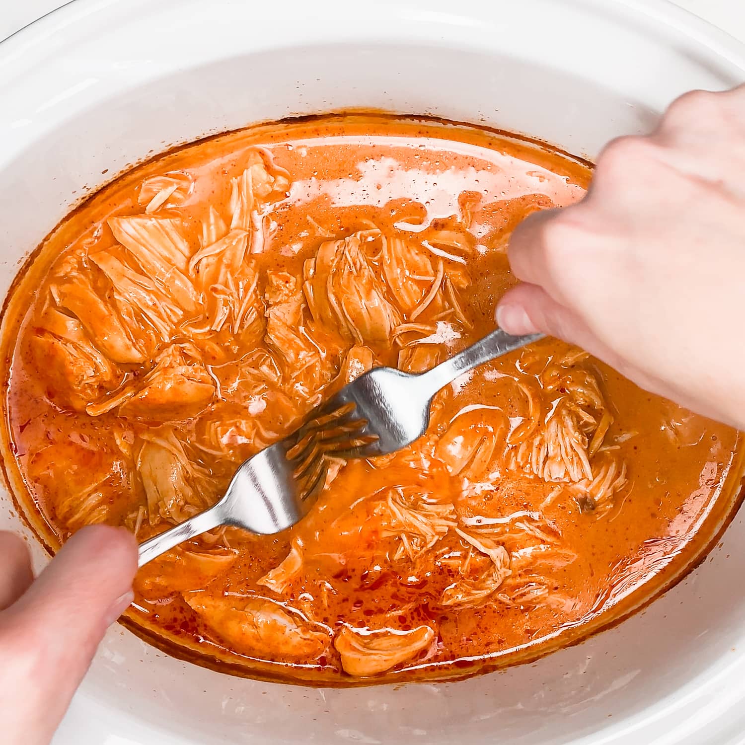 shredding buffalo chicken in the slow cooker