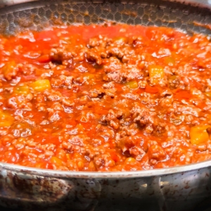 sloppy joe filling in a skillet for making sloppy joe cornbread cups