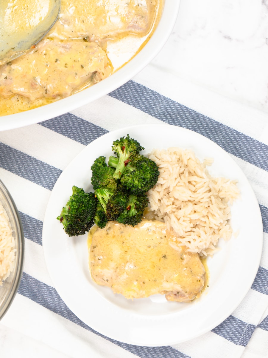 slow cooker ranch pork chops, broccoli, and rice on a plate