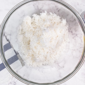 sweetened shredded coconut in a glass mixing bowl