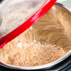 adding brown rice to the pressure cooker