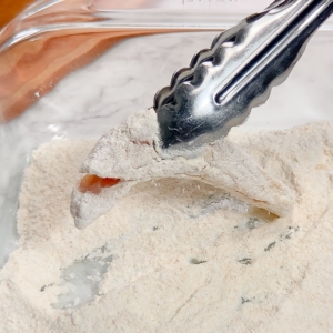 coating a chicken tender in gluten-free breading