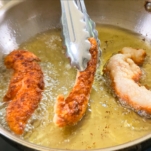 frying gluten free chicken tenders in a skillet