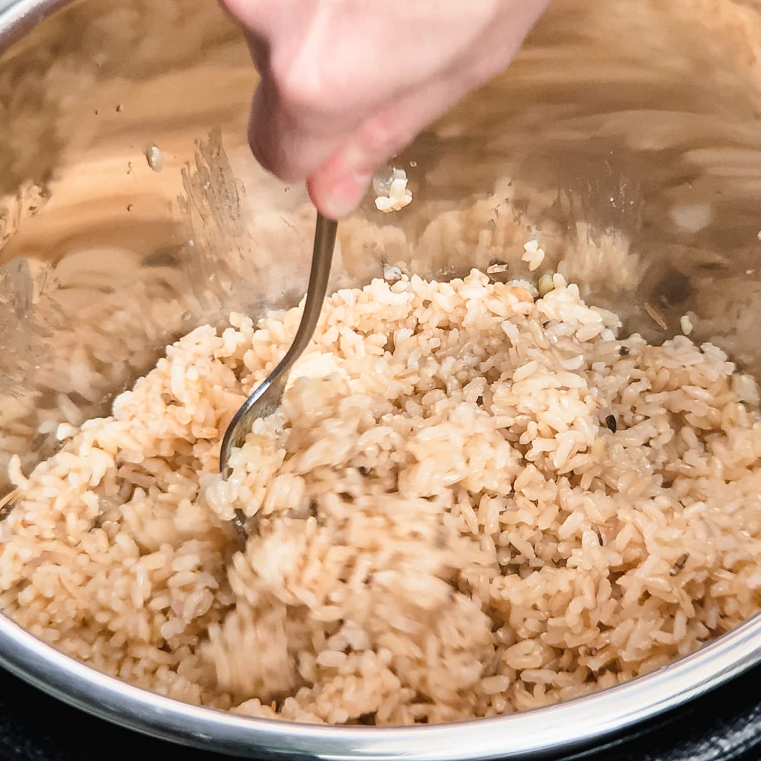 using a fork to fluff brown rice in the instant pot