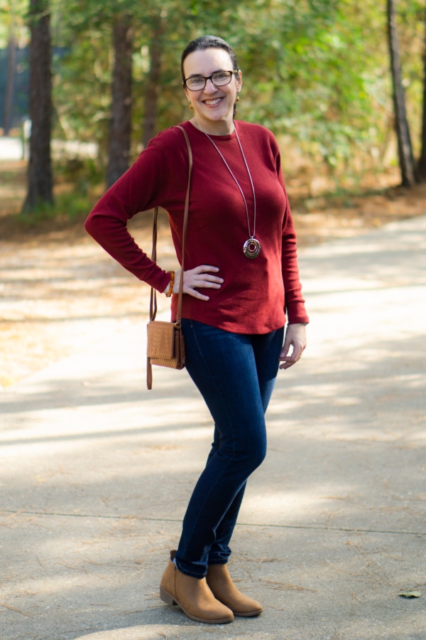 valerie standing on a walkway in a park showing off her winter outfit