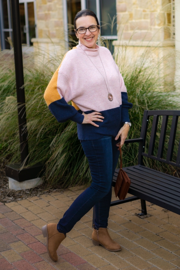 valerie posing in her new winter fashions from Walmart in front of a bench at a shopping center