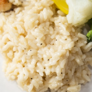 a dinner plate served with parmesan risotto