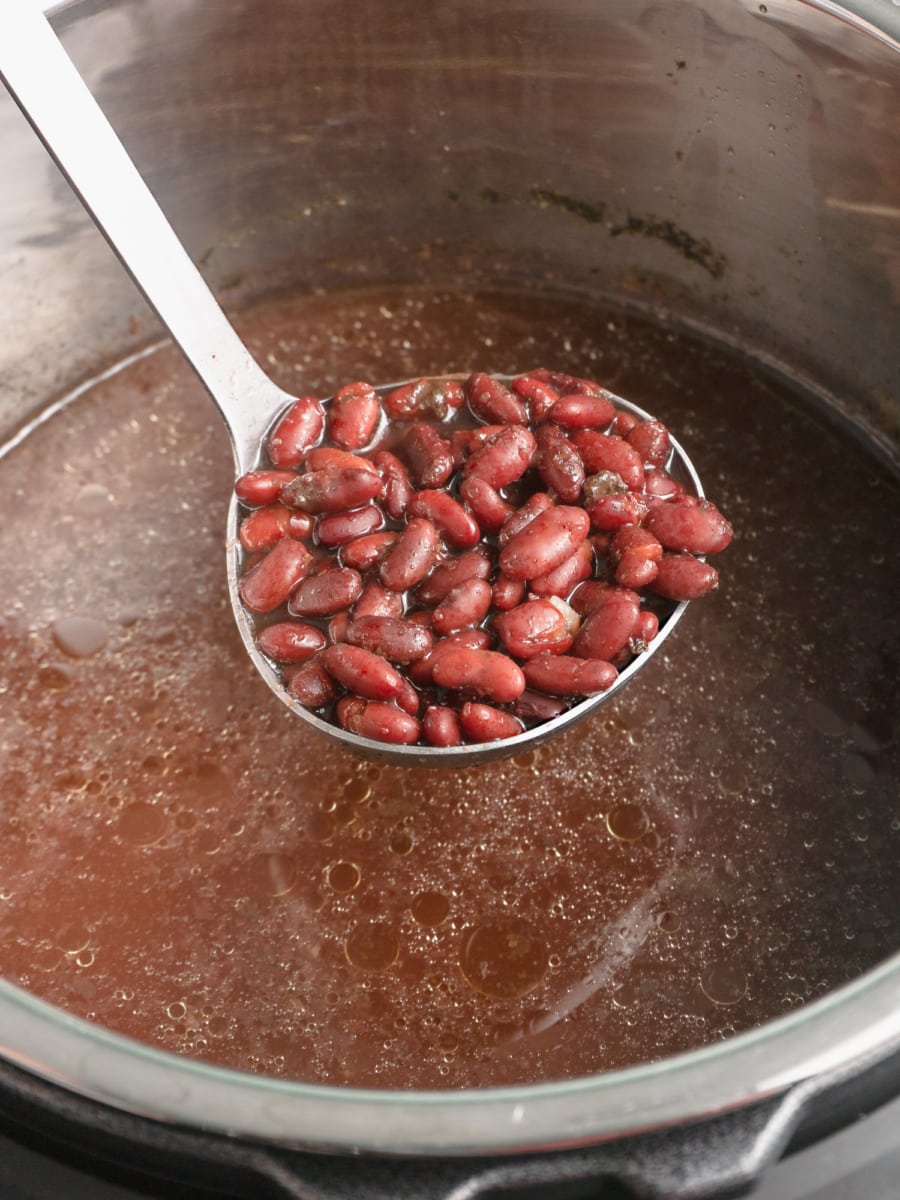 a ladle of red beans over the instant pot