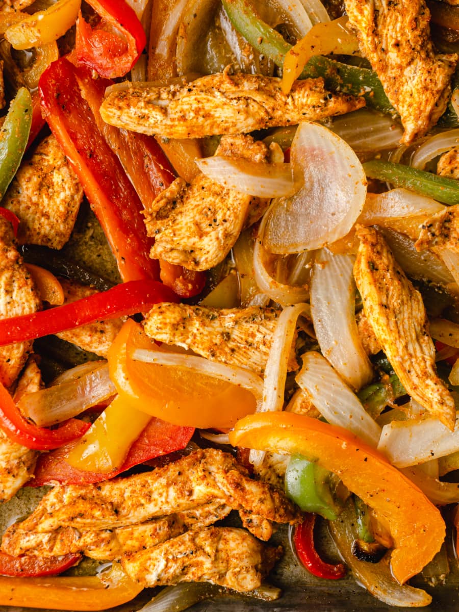 close up of sheet pan chicken fajita chicken and bell peppers and onions