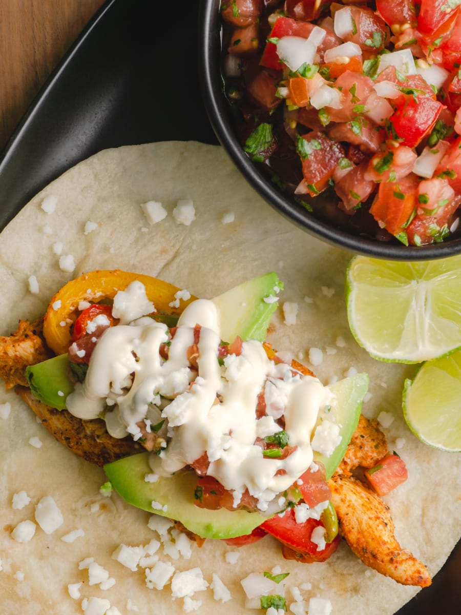 overhead shot of a sheet pan chicken fajita on a plate