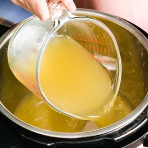 adding chicken stock to the instant pot