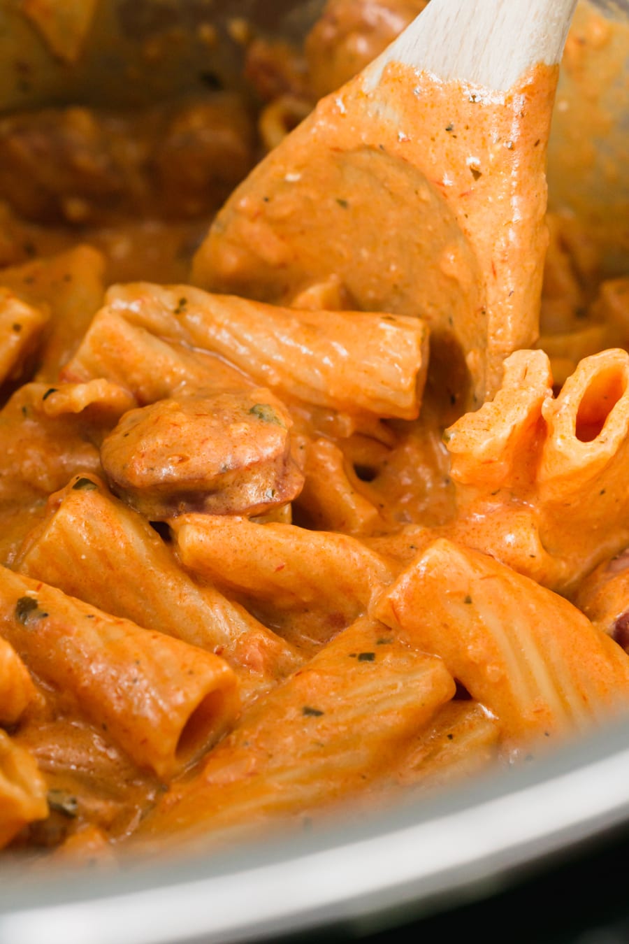 a close up of cream cheese pasta with sausage in the instant pot pressure cooker