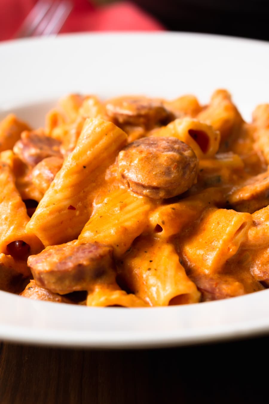 a bowl of cream cheese pasta with sausage