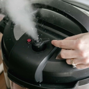 moving the pressure release valve to venting to release the remaining pressure from the instant pot