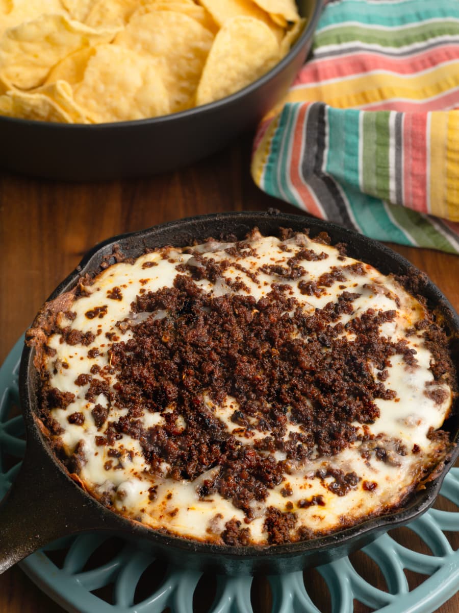 a honduran anafre with beans, cheese, and chorizo in a skillet