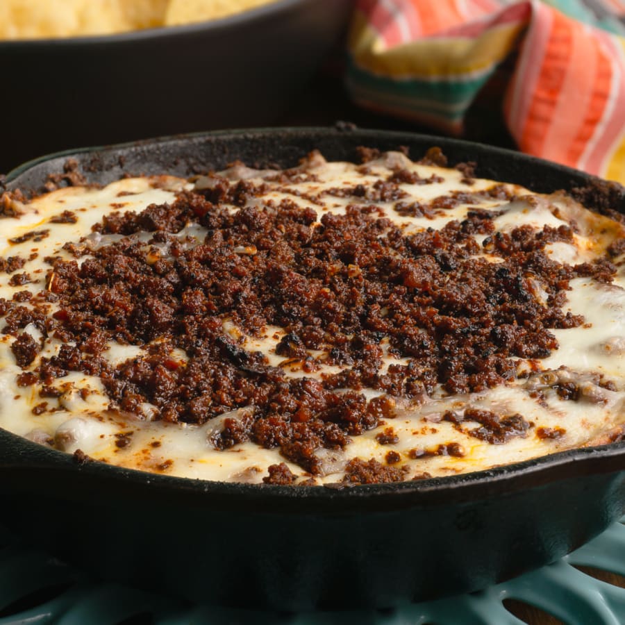 anafre hondureno or a bean, cheese, and chorizo dip served in a skillet