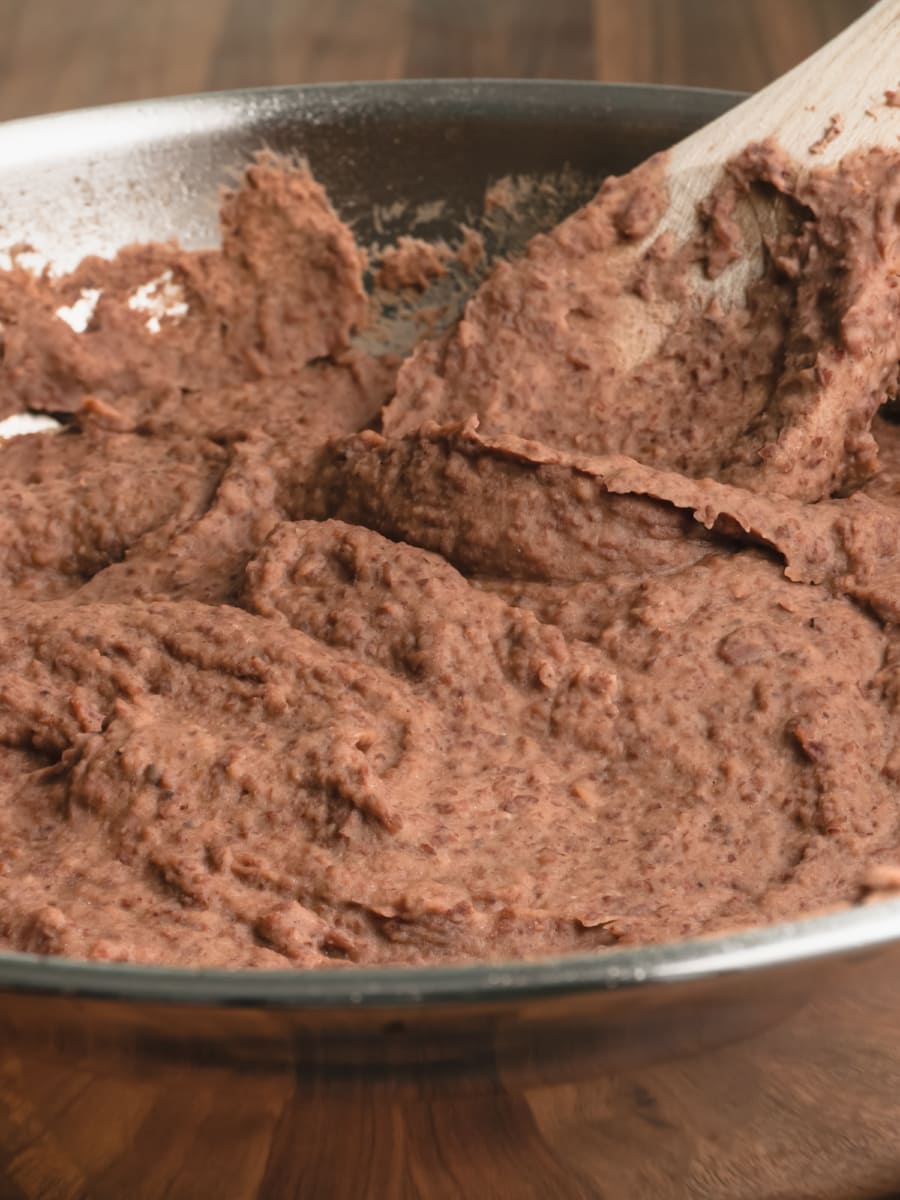 frying pan filled with refried beans on the counter