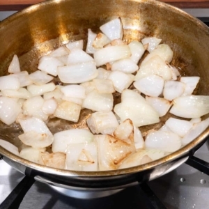 sautéing onions in a frying pan