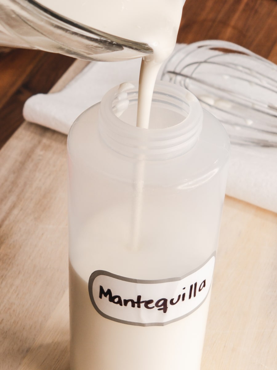 mantequilla ralla or honduran crema being poured into a bottle