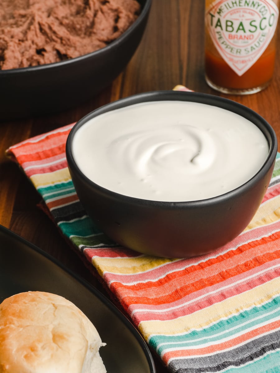 honduran crema in a bowl served with bread and beans