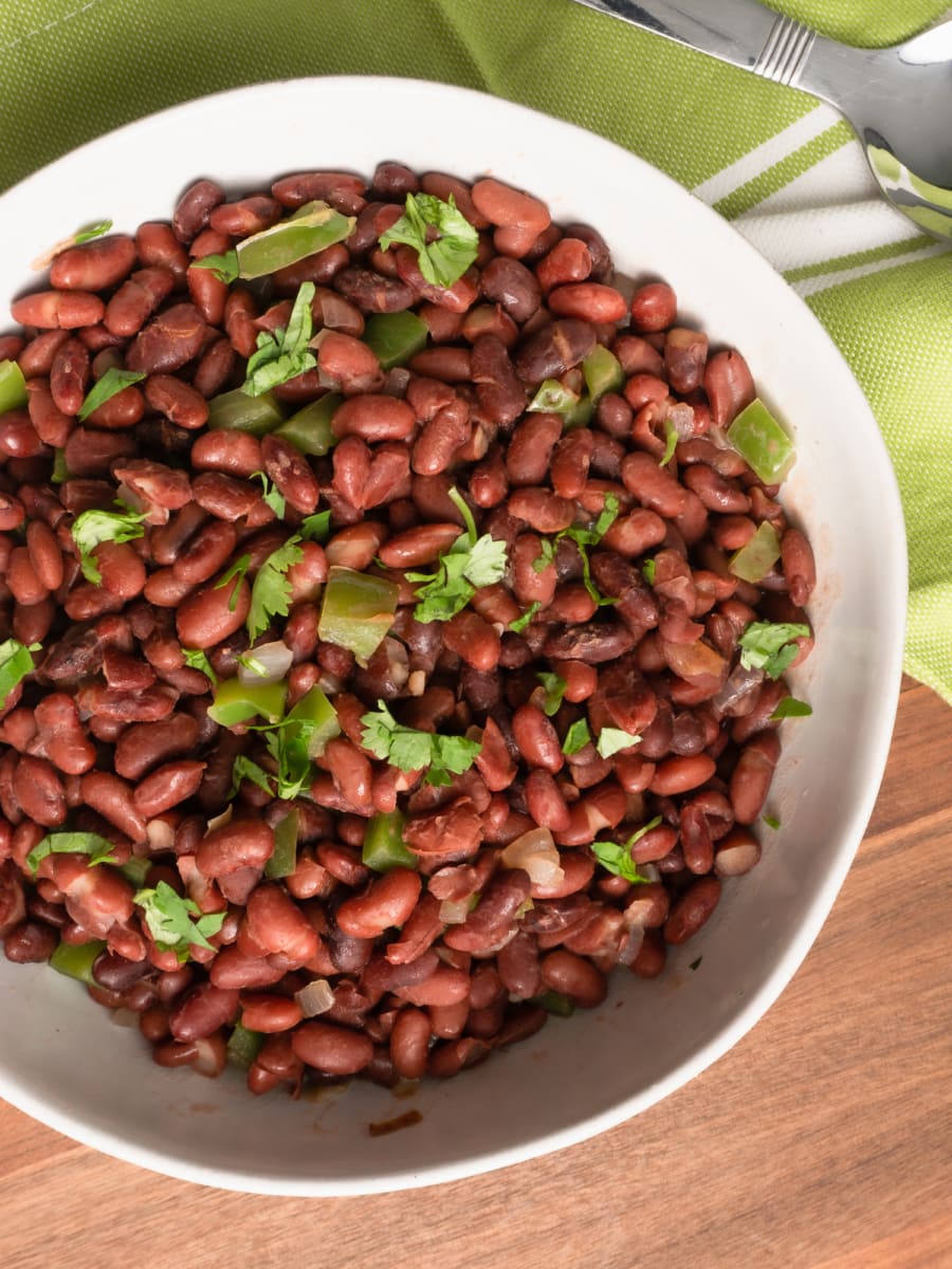 overhead shot of a bowl of honduran red bean stew garnished with cilantro