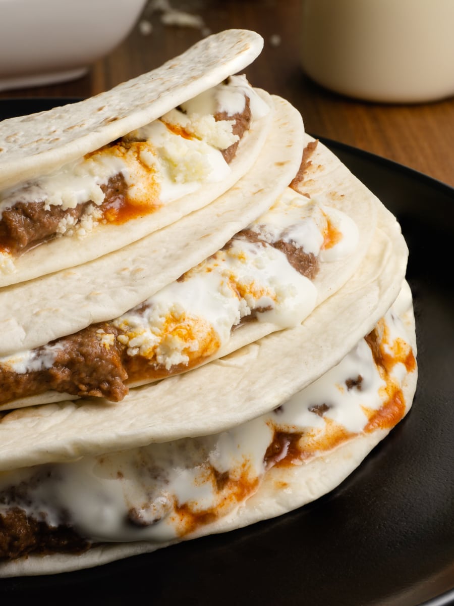 close up of honduran baleadas stacked up on a plate