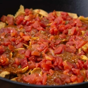 layers of corn chips, chili, and rotel in a large skillet to make frito pie casserole