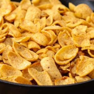 adding a final layer of corn chips to make frito pie