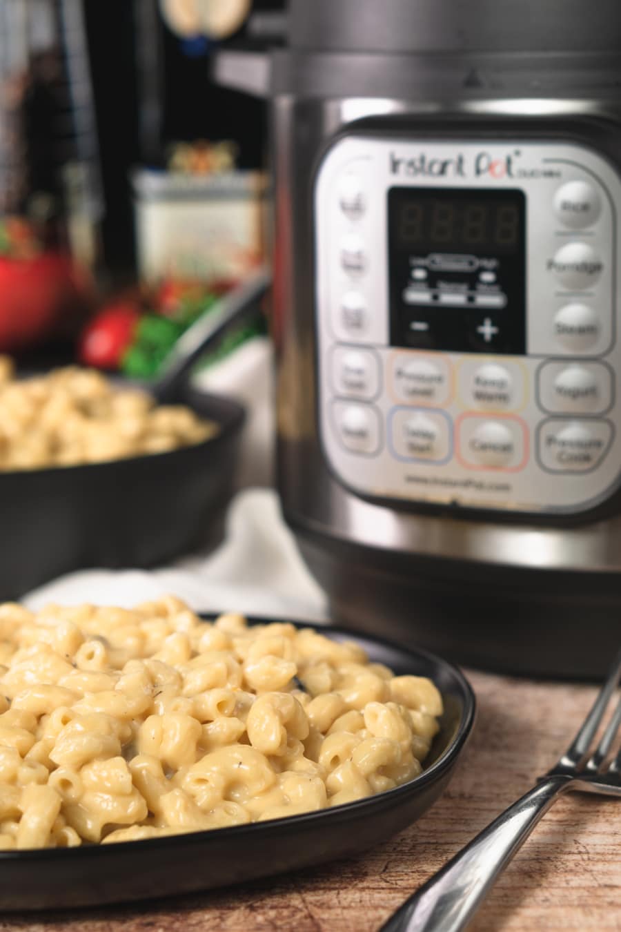 a large plate of macaroni and cheese made with cream of mushroom soup sitting on the counter with the instant pot in the background