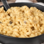 a large bowl full of macaroni and cheese made with cream of mushroom soup sitting on a counter