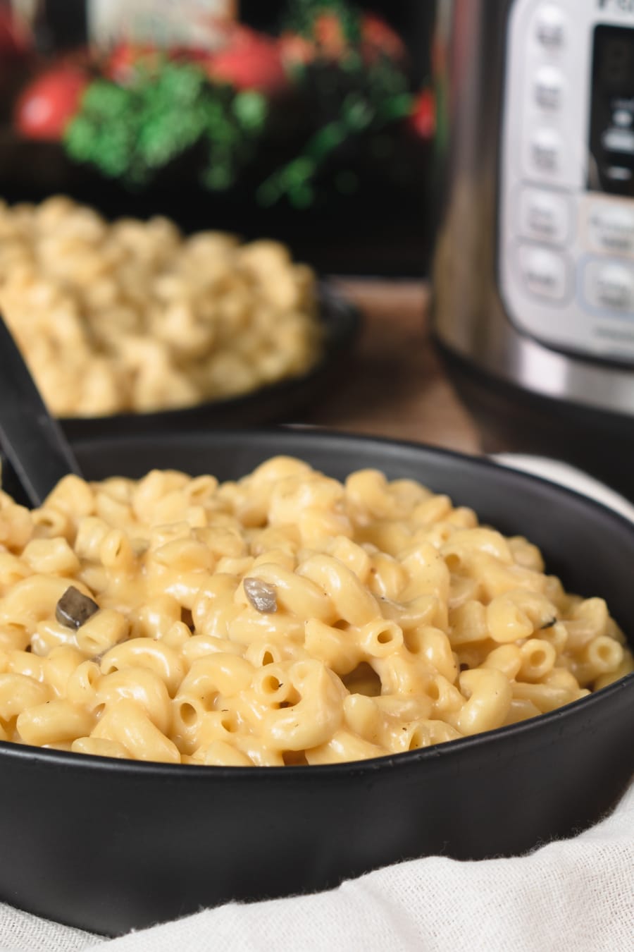 a large bowl full of macaroni and cheese made with cream of mushroom soup sitting on a counter